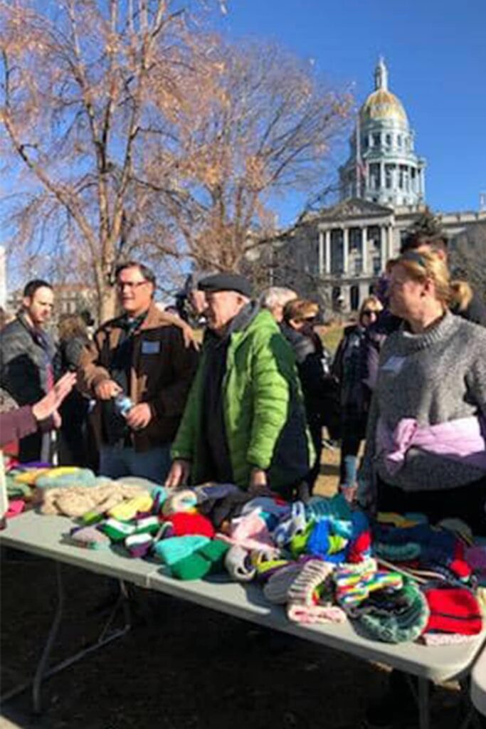 people infront of capitol building with tables and mittens gloves