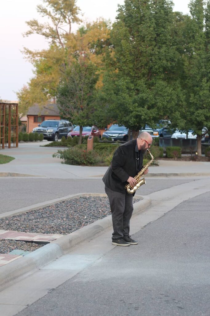 Man playing saxophone outside
